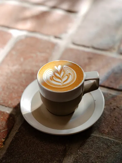 Latte art in a ceramic cup at Sociology
