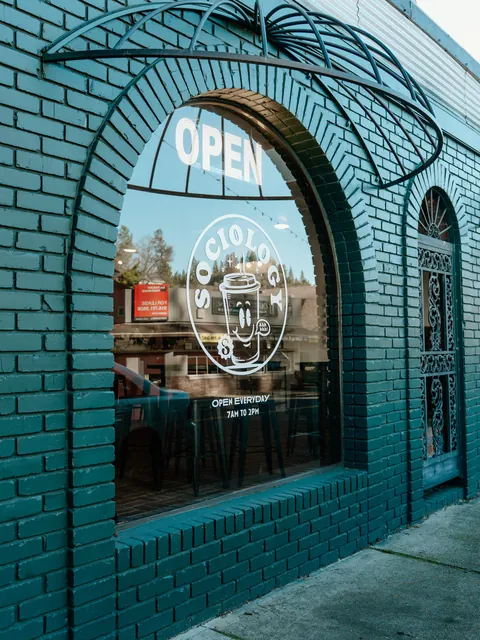 Sociology’s green brick storefront and arched window on Main Street in Placerville
